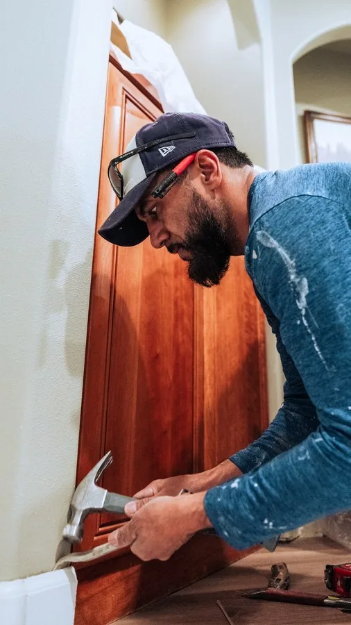 A contractor installing cabinet trim, shot during a client production